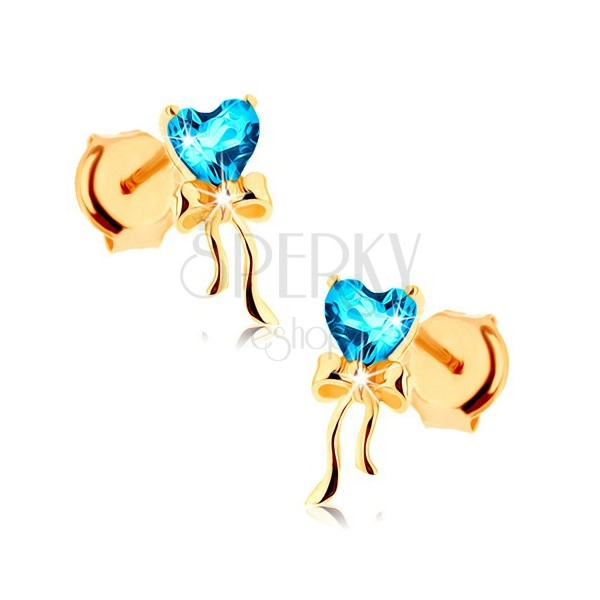 Złote kolczyki 585 - lśniąca kokardka, niebieskie topazowe serduszko