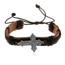 Skórzana bransoletka brązowego koloru z czarnymi sznurkami, ozdobnie wycięty krzyż